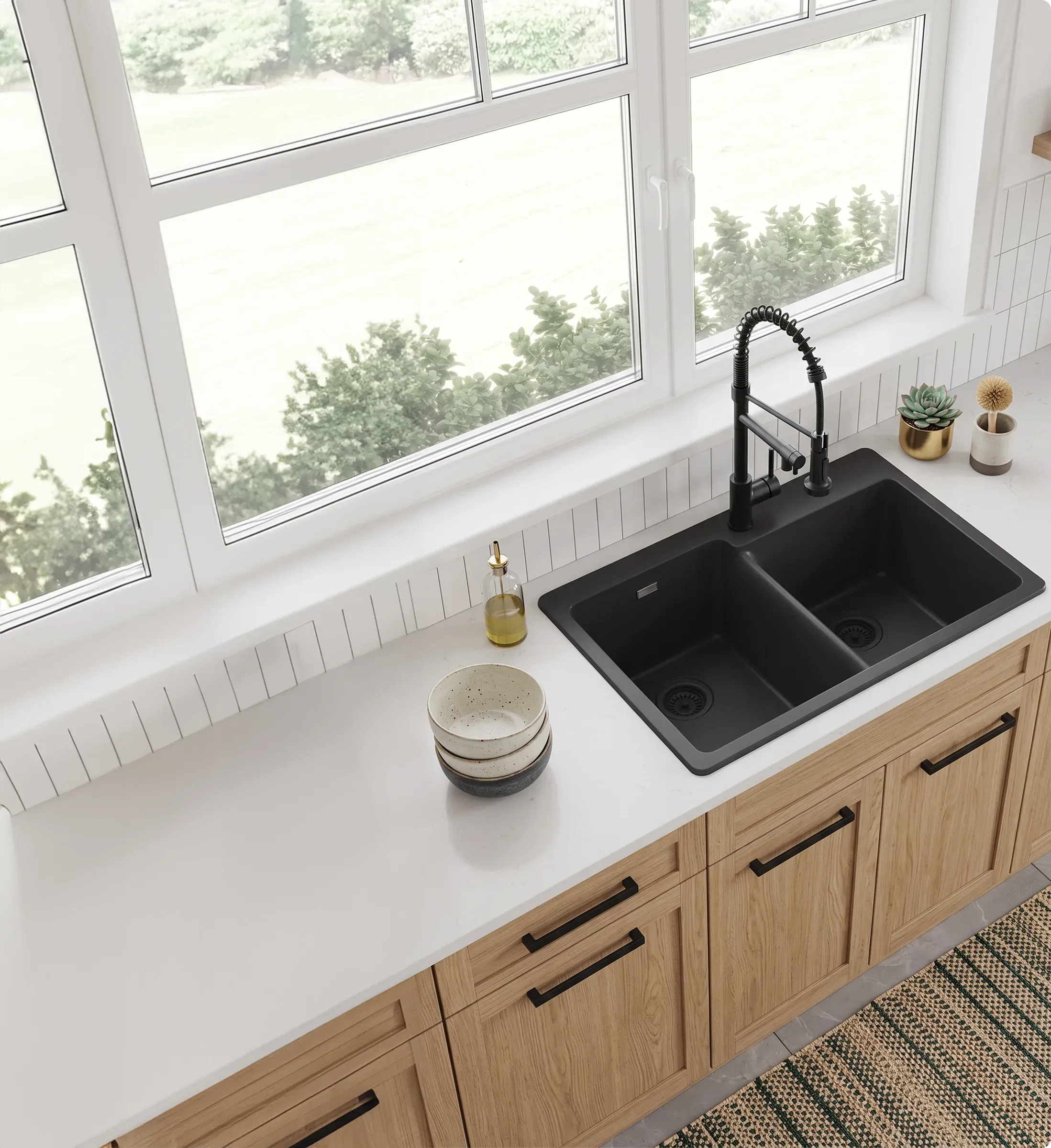 Black double-bowl quartz sink with a black spring-neck faucet under a bank of windows