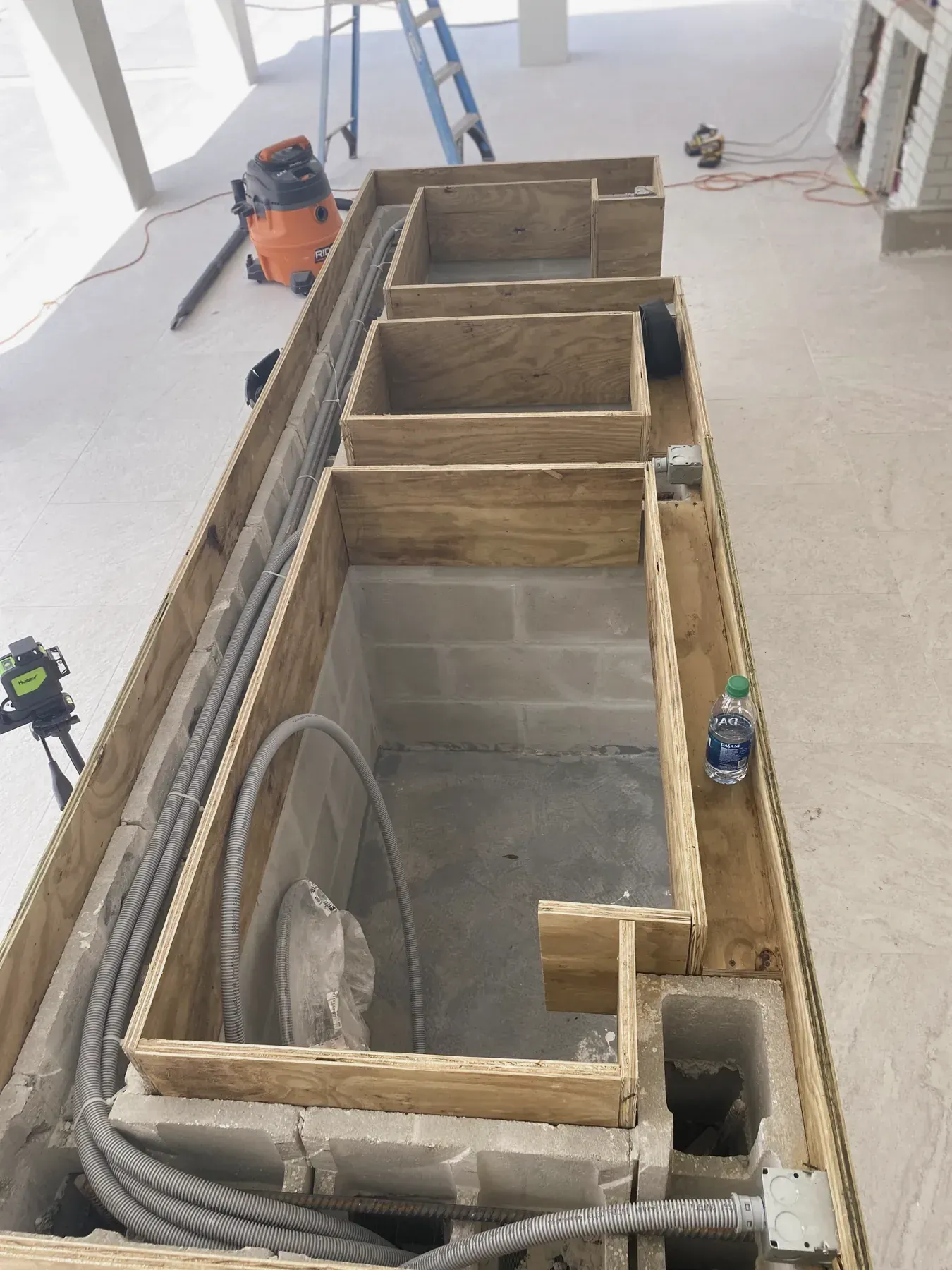 Poured concrete form for a stone countertop base on a job site