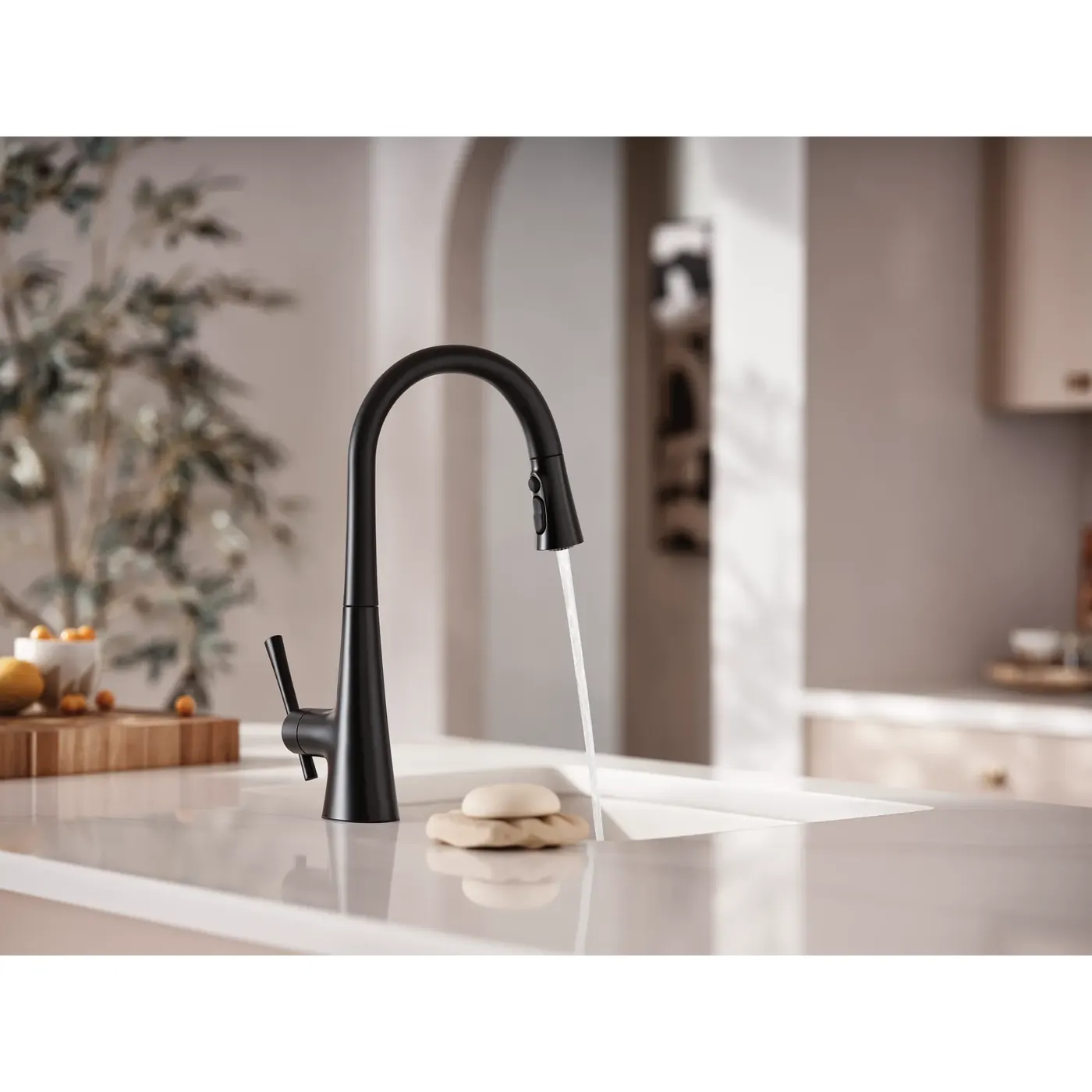 Matte black Moen Kurv faucet with running water over a stone counter